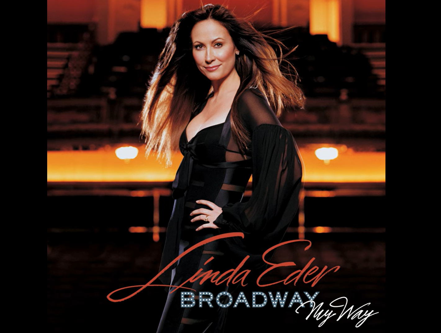 Linda Eder posing confidently in a theater setting.